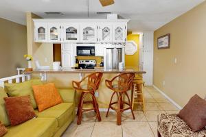 a living room with a couch and a kitchen at Sailor's Dream in Port Isabel