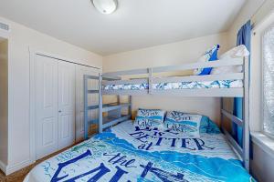 a bedroom with two bunk beds with blue pillows at Montana Memory Maker in Polson