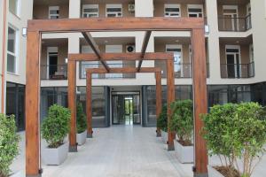 an entrance to an office building with a wooden structure at Holiday Gateway in Shëngjin
