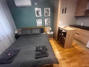 a bedroom with a bed and a desk in it at Apartman Vera in Kruševac