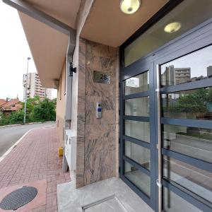 an entrance to a building with a glass door at Apartman Vera in Kruševac
