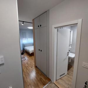 a room with a closet and a bedroom with a bed at Apartman Vera in Kruševac +19 photos