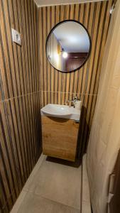 a bathroom with a sink and a mirror at Polichrono Cosy Summer House in Polykhrono