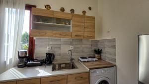 a kitchen with a sink and a washing machine at Polichrono Cosy Summer House in Polykhrono +1 photo