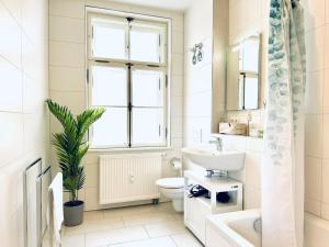 a bathroom with a sink toilet and a window at E&K living - design Apartments - SKY-TV - Audi - IN village - free parking in Ingolstadt +183 photos