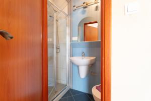 a bathroom with a sink and a shower at Pokoje gościnne Przystań in Dębki +53 photos