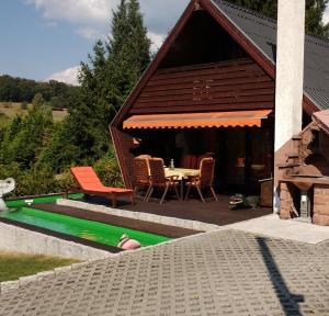 a house with a table and chairs and a pool at Haus Tsavo in Wald-Michelbach