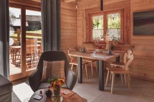 a dining room with a table and chairs on a porch at Domki na Stecówce in Istebna