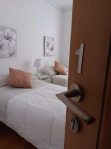 a door open to a bedroom with a bed and a couch at Apartamento Amplio, Céntrico y Familiar CIUTAT VELLA in Valencia