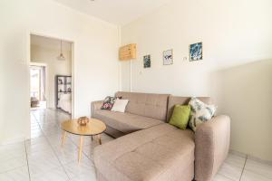 a living room with a couch and a table at Gs house in Heraklio Town