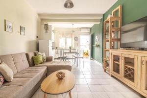 a living room with a couch and a table at Gs house in Heraklio Town