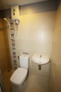 a small bathroom with a toilet and a sink at Nine Place Sukhumvit 40 in Bangkok