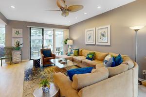 a living room with a couch and a table at Harbour Town Club Villas 1253 in Hilton Head Island