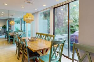 a dining room with a wooden table and chairs at Harbour Town Club Villas 1253 in Hilton Head Island