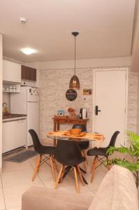a kitchen and dining room with a table and chairs at LANDSCAPE SOLAR - Beira Mar de Fortaleza in Fortaleza