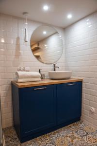 a bathroom with a blue sink and a mirror at Przystanek Wieś in Rząśnik +41 photos