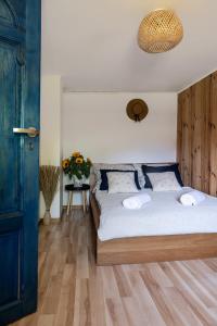a bedroom with a large bed with a wooden headboard at Przystanek Wieś in Rząśnik