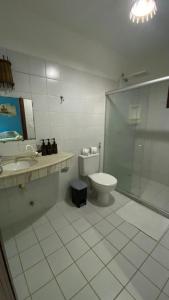 a bathroom with a toilet and a sink and a shower at Chez Max Pousada in Morro de São Paulo