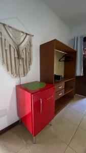 a red cabinet in a room with a mirror at Chez Max Pousada in Morro de São Paulo