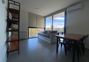 a living room with a table and a couch at Pionero in Neuquén