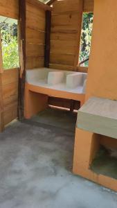 a room with two beds and two windows at Casa del Arroyo 2-Bedroom Cottage Fireplace and BBQ in Jarabacoa