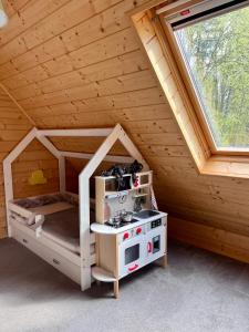 a room with a bed and a stove in a cabin at Chalúpka in Stará Ľubovňa