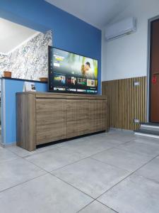 a room with a large flat screen tv on a wall at Blu Etna Casa Vacanze in Zafferana Etnea