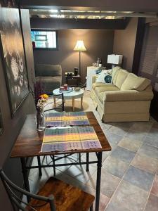 a living room with a table and a couch at Private Studio Apartment-Pet Friendly in Downers Grove