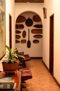 Hotel Mariscal Robledo في سانتا في دي أنتيوكيا: غرفة طعام بها جدار من الأواني والمقالي