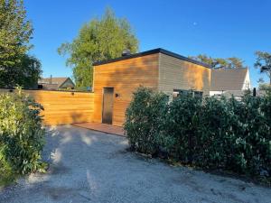 a house with a wooden fence and a door at Hidden gem by the sea in Beddinge Strand