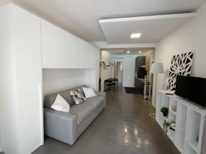 a living room with a couch and a television at Monolocale Farina in Cagliari