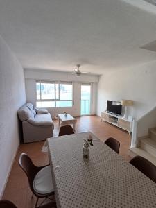 貝尼多姆的住宿－Bonito triplex con increíbles vistas，客厅配有桌子和沙发