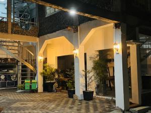 a courtyard of a house with lights and plants at The SD Apartment in Camiling