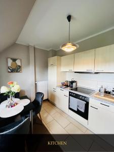 a kitchen with a table and a small kitchen with a table and chairs at Boutique Appartement in Torgau