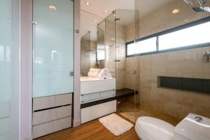 a bathroom with a glass shower and a toilet at Energy Living - Ultimate Condo in Medellin in Medellín +39 photos