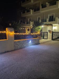 a building with lights in front of it at night at Sea view studio in Kírra