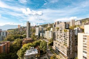 an aerial view of a city with tall buildings at Energy Living - Ultimate Condo in Medellin in Medellín