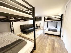 a bedroom with two bunk beds and a couch at Hill City Haven Downtown Main Street in Hill City