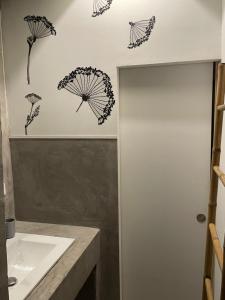 a bathroom with four umbrellas on the wall at Maison Capbreton à 4 min des plages in Capbreton