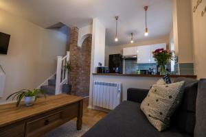 a living room with a couch and a table at THE COSY HOME BY KS - Free Parking, WI-FI, Smart TV, Kitchen, Washing machine, Long Stays Welcomed in Hereford