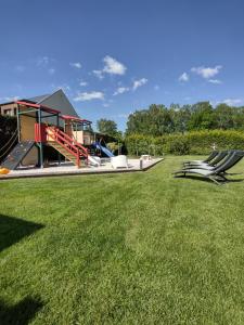 a park with a slide and a playground at Villa Cork in Dębki