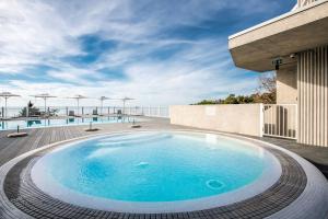 a swimming pool on the roof of a building at Green Cape Botanico in Batumi