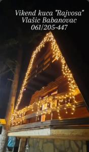 a building with christmas lights on top of it at Vikendica Rajvosa Vlašić in Šišava