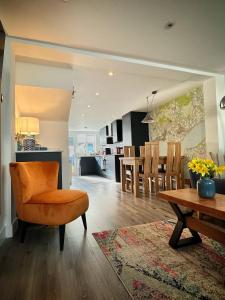 a living room and kitchen with a table and chairs at Sea Walk Cottage, Milford On Sea in Milford on Sea