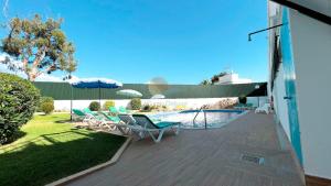 a patio with chairs and a swimming pool at Albufeira Calipto by Sunny Deluxe in Albufeira