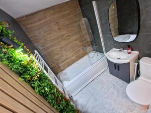 a bathroom with a shower toilet and a sink at Azzur Studios Aparthotel in Constanţa +39 photos