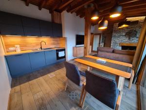a kitchen and dining room with a table and a sink at Vista Villa at Katarino SPA in Bansko