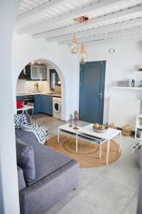a living room with a white table and a couch at Sand Lily Villa Mykonos in Mýkonos City +28 photos