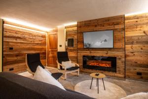 a living room with a couch and a fireplace at Apartments Les Crouses in Valtournenche