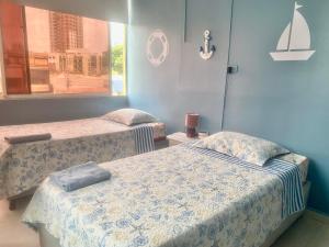 a room with two beds and a window at Apartamento en Cartagena in Cartagena de Indias
